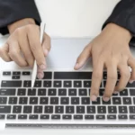 Person Typing at Keyboard